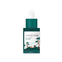 Load image into Gallery viewer, ROUND LAB Pine Calming Cica Ampoule is a soothing and hydrating serum formulated with Pine Extract and Centella Asiatica Extract to calm irritated skin and strengthen the skin barrier. It features a combination of Hyaluronic Acid and its derivatives to deeply moisturize, while Asiaticoside, Asiatic Acid, Madecassoside, and Madecassic Acid provide additional calming and skin-repairing benefits. This ampoule is ideal for sensitive skin, promoting a balanced and healthy complexion.